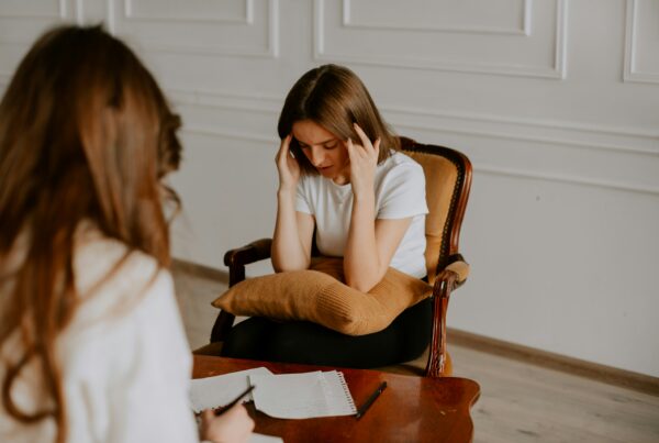 person in therapy session speaking with a clinician about dual diagnosis treatment for mental health and substance use disorders