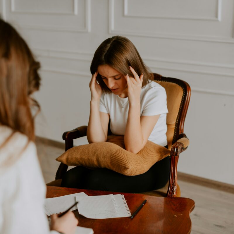 person in therapy session speaking with a clinician about dual diagnosis treatment for mental health and substance use disorders