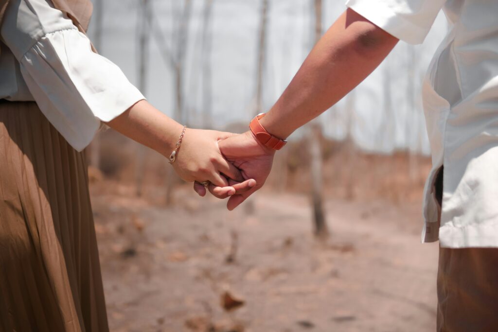 two people holding hands outdoors representing support during dual diagnosis mental health and addiction treatment in Texas at The Heights Treatment Houston Evidence Based Dual Diagnosis Treatment Center