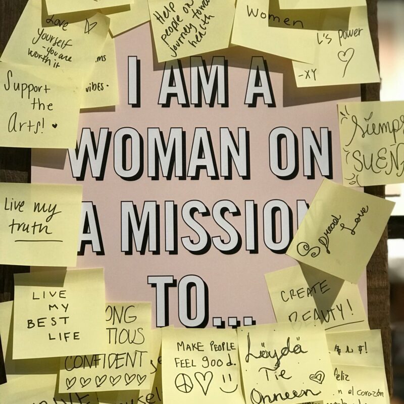 motivational notes around a sign about women on a mission representing empowerment and women's mental health awareness